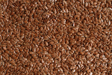 Food backgroud of raw shelled flax seeds