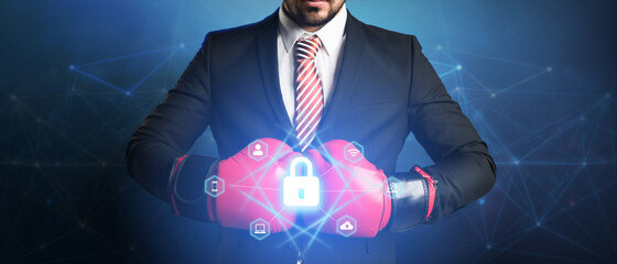 businessman with boxing glove and digital interface showing devices around a lock symbol on...