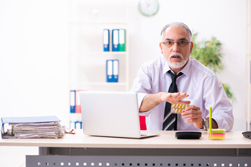 Old sick employee suffering at workplace