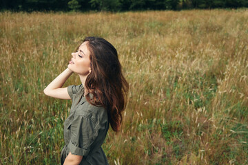 Woman in a meadow enjoying nature closed eyes sun 