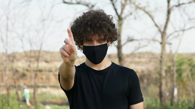 denial, forbid - young man wearing the mask makes no to the camera