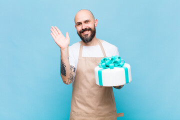 bald man smiling happily and cheerfully, waving hand, welcoming and greeting you, or saying goodbye