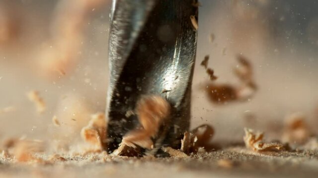 Super slow motion of detail of a drill bit drilling into wood. Filmed on high speed cinema camera, 1000 fps.