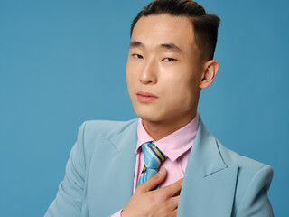 Gentlemen in fashionable suit on a blue background portrait close-up