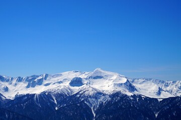 Scenes from the life of a ski resort, beautiful views of winter snow-capped mountains and blue skies.