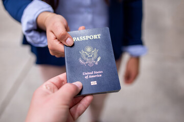 A beautiful young business woman holding a blue American passport