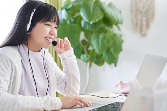 リビングでオンライン講義を受ける日本人女子中学生