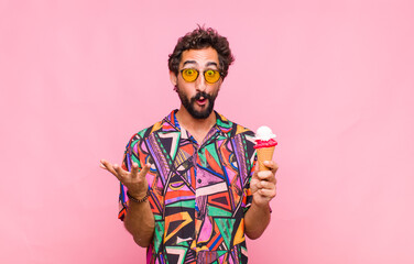 young bearded man feeling extremely shocked and surprised, anxious and panicking, with a stressed...