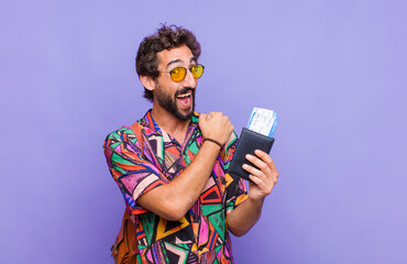 young bearded man feeling happy, positive and successful, motivated when facing a challenge or...