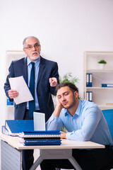 Old boss and his young assistant in the office