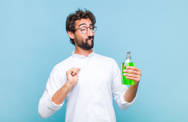 young bearded man looking arrogant, successful, positive and proud, pointing to self