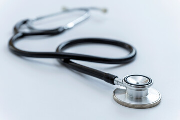 CLOSE UP OF A STETHOSCOPE ON THE DOCTOR'S DESK. HEALTH AND MEDICAL INSURANCE CONCEPT.