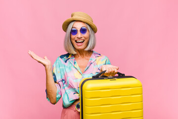middle age woman feeling happy, excited, surprised or shocked, smiling and astonished at something...