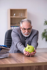 Fototapeta premium Old male employee in budget planning concept
