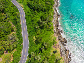 Curve asphalt road on mountain sea island with tree forest