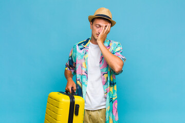 young handsome man feeling bored, frustrated and sleepy after a tiresome, dull and tedious task,...