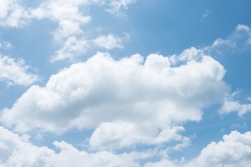 The blue sky background with tiny clouds closeup