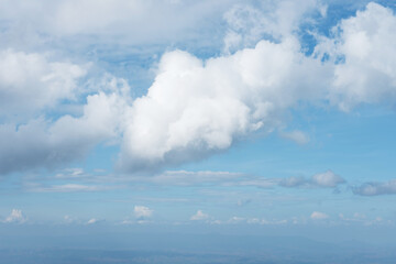 The blue sky background with tiny clouds closeup
