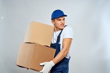 working man in uniform with boxes in his hands delivery loader lifestyle