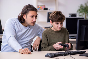 Father and son playing computer games