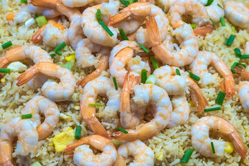 Shrimp fried rice and soy sauce with shrimp on top in the pan to make it look appetizing at the local market.
