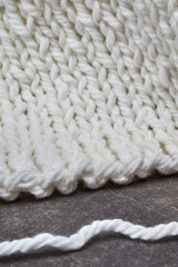 white wool knitted lies on gray background
