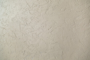 The wall is decorated with decorative plaster for concrete, plaster. Light in color.