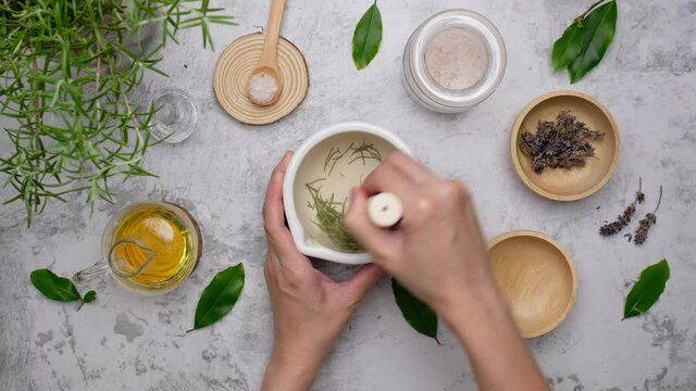 hands holding a bowl of fresh herbs