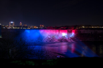 The American portion of Niagara Falls is lit in red, white, and blue at the Niagara Winter Festival...