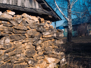 old stone barn in the village in spring