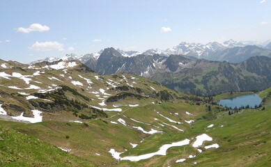 Fototapeta na wymiar Mountains with snow and lake in alps, beautiful view
