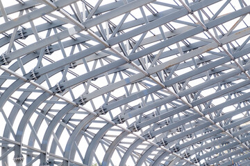 Row of stadium roof metal supports structure. Industrial steel background.