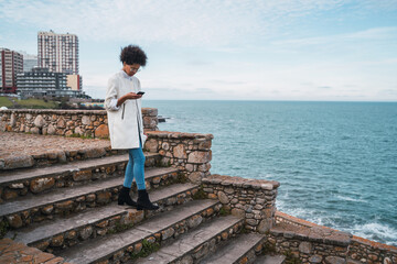Young woman using her mobile phone.