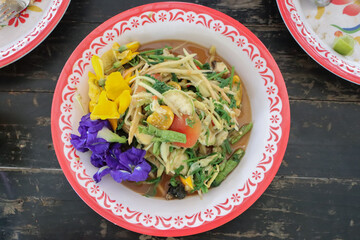 Green papaya salad on dark table