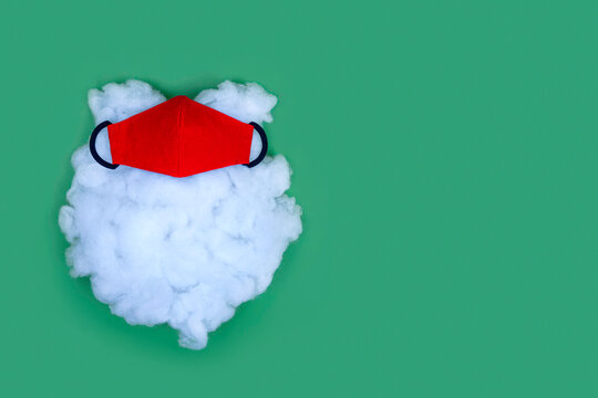 Santa beard with red protective mask. Quarantine Christmas and New Year 2021. Minimal concept with copy space.