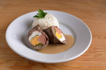Stewed meat roll with sausage, boiled egg and cucumber