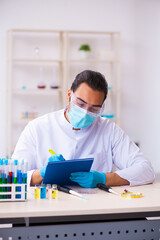 Young male chemist working in the lab