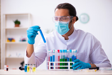 Young male chemist working in the lab
