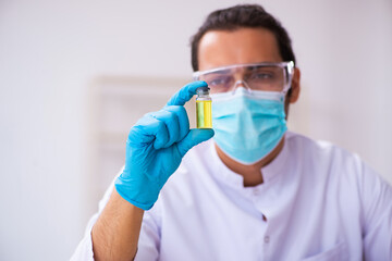 Young male chemist working in the lab