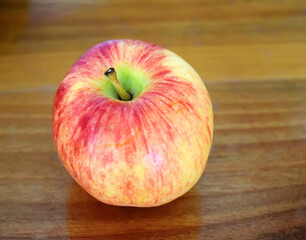 red apple on wooden table