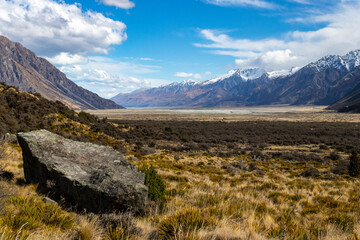 rock in front of mountain slopes and plains