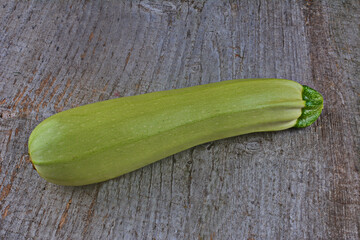 Homegrown zucchini on vintage table.The prepared organic zucchini is placed on the cutting board,