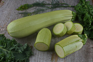 Homegrown zucchini on vintage table.The prepared organic zucchini is placed on the cutting board,