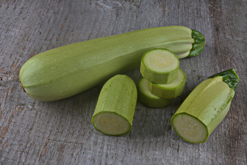 Homegrown zucchini on vintage table.The prepared organic zucchini is placed on the cutting board,