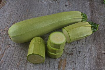 Homegrown zucchini on vintage table.The prepared organic zucchini is placed on the cutting board,