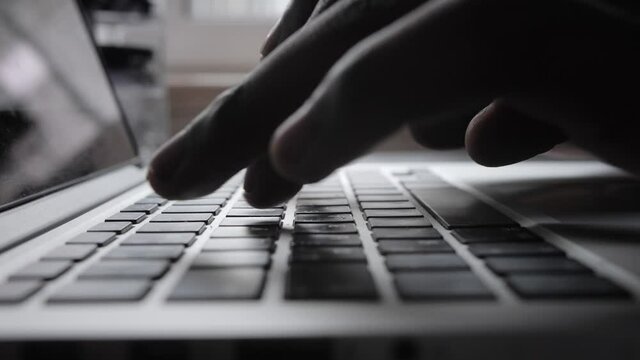 Male african american user hands typing on laptop keyboard sit at table, mixed race ethnic student professional study work with pc software technology concept, close up view
