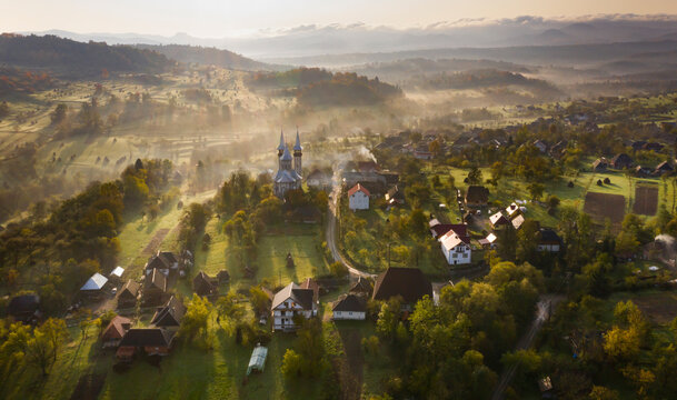 Aerial view over small rural village of Breb in magic sunrise.