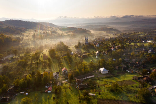 Aerial view over small rural village of Breb in magic sunrise.