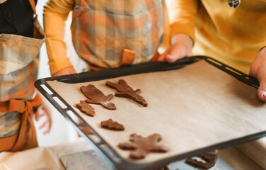 Fototapeta na wymiar Preparing Gingerbread Cookies in Kitchen for December Holidays