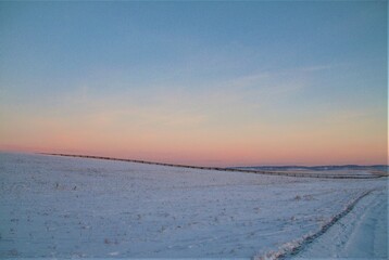 snowfield. snow glade at sunset.winter background